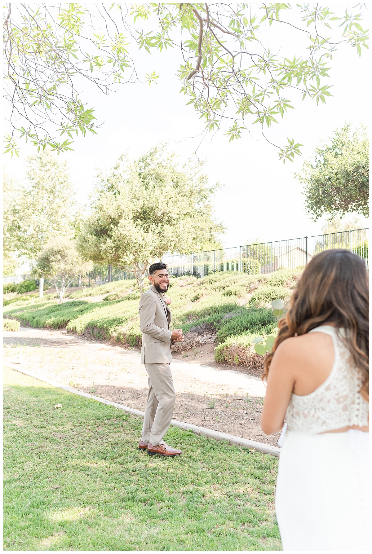 man looking at his bride during first look