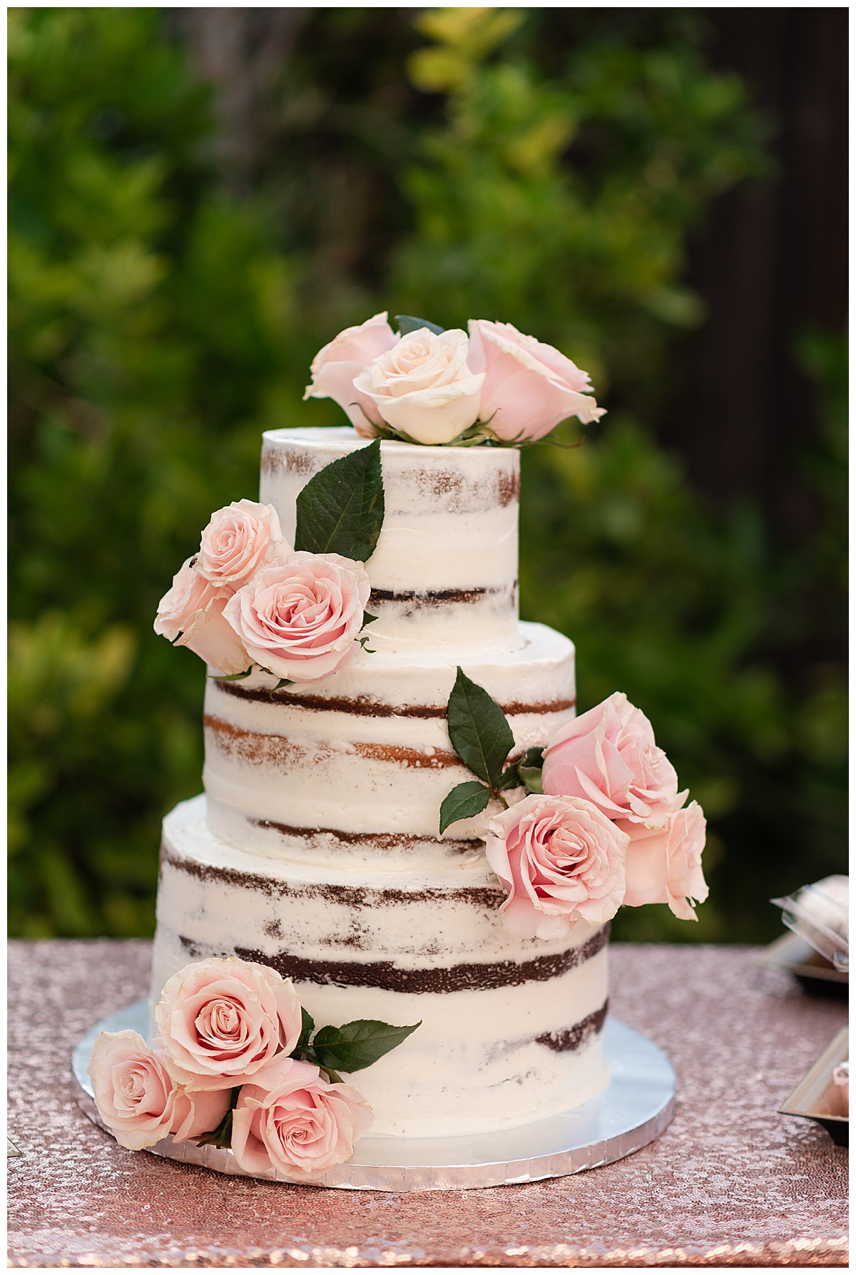 pink and white wedding cake with real pink roses