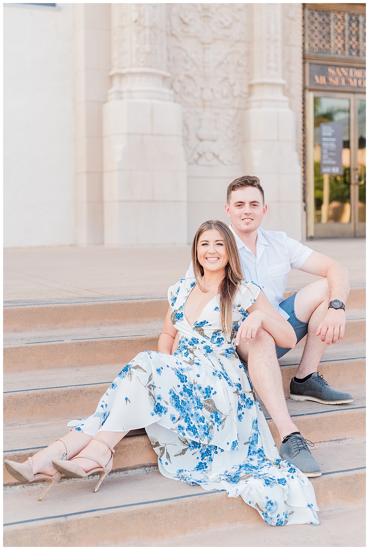couple sitting on steps at balboa park