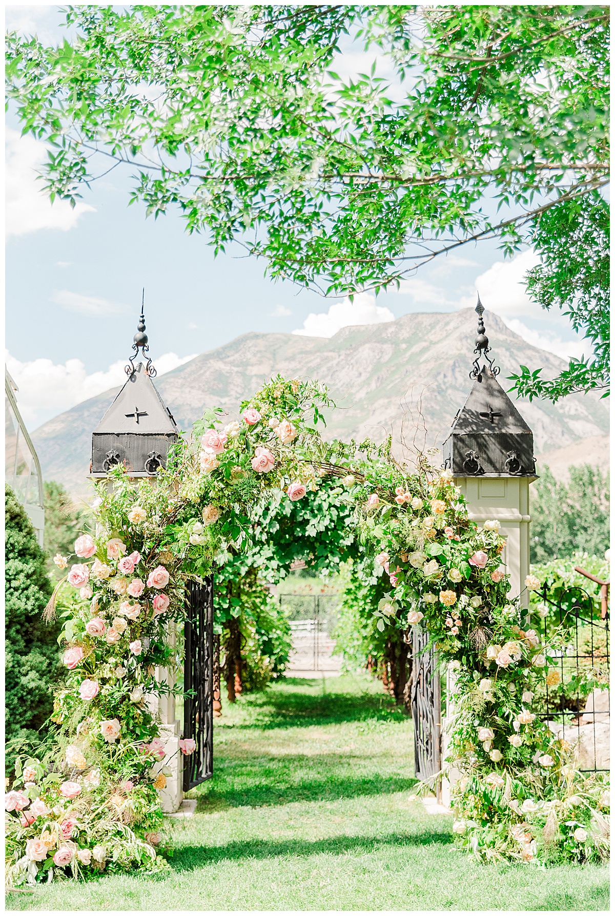 green archway with beautiful flowers